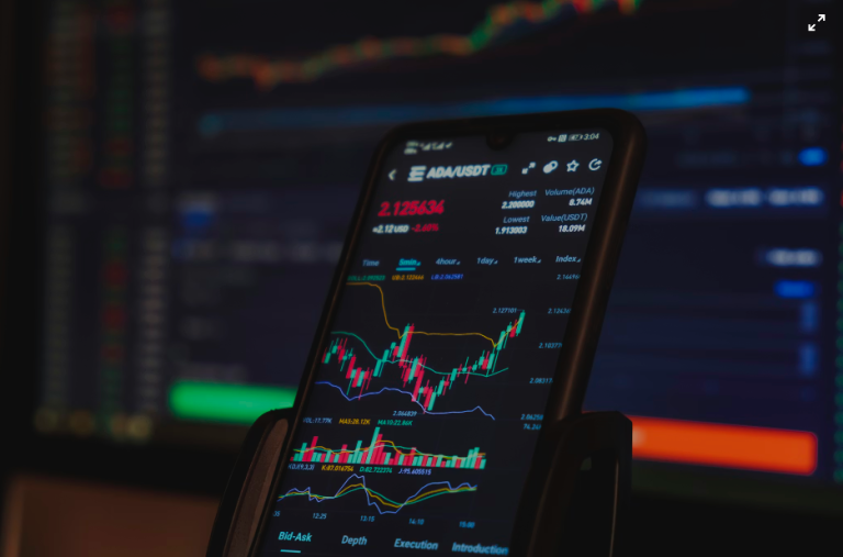 A phone showing the growth chart of a particular cryptocurrency. Courtesy of Pexels}