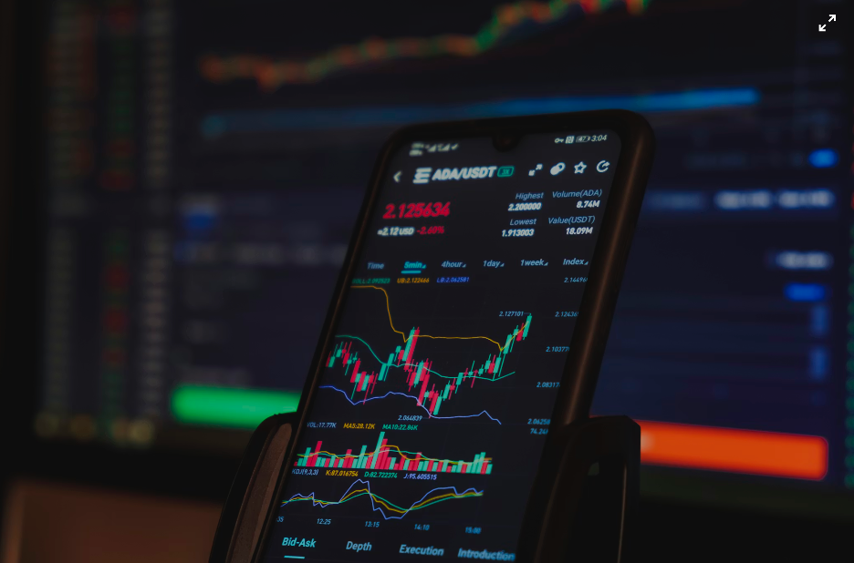 A phone showing the growth chart of a particular cryptocurrency. Courtesy of Pexels}